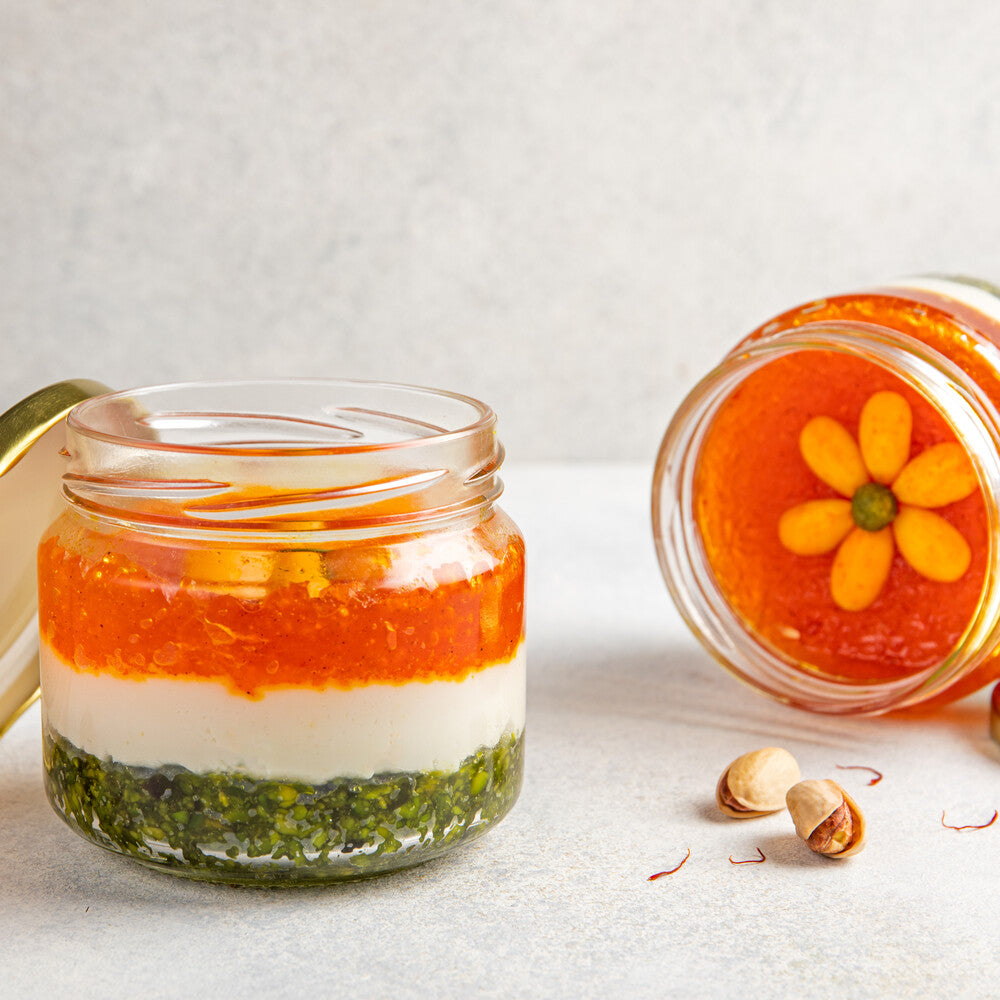 Elegantly layered jar with juicy Kesaria Petha, creamy chenna, and nutty pistachio, creating a visually appealing dessert presentation