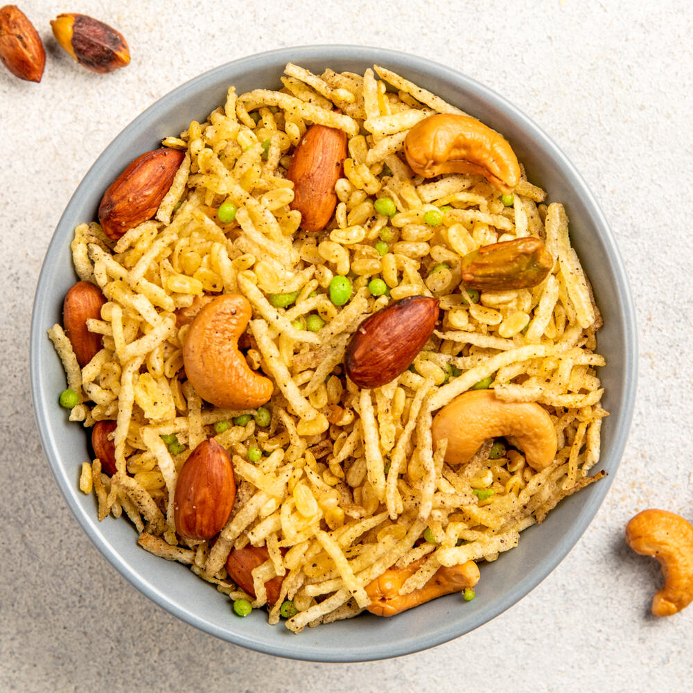 Bowl filled with a tangy mixture of Aloo Lachha, Moongdal, Boondi, Dry fruits and spiced with special masala
