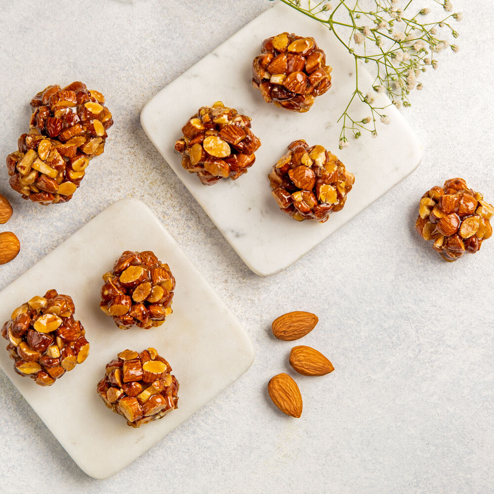 Pieces of caramelized badam combined into a laddu.