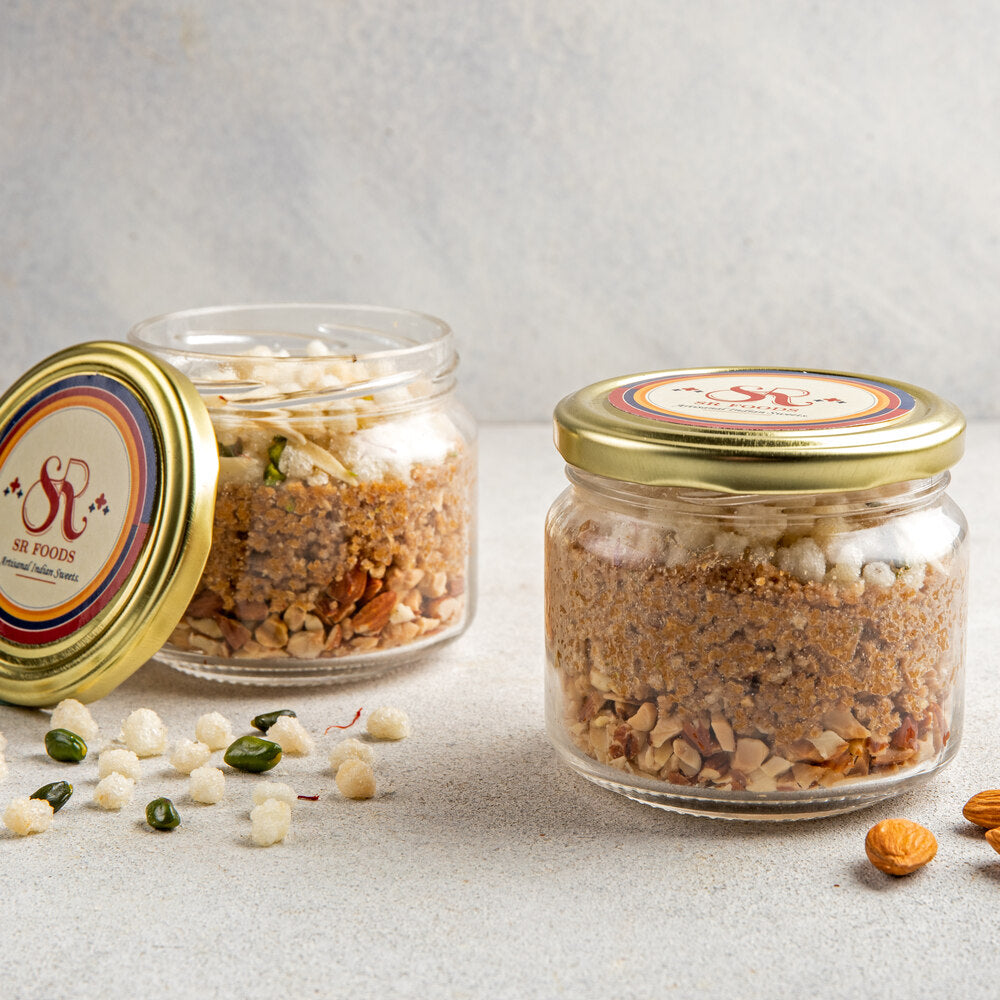 Elegantly layered jar with almonds, deconstructed gond laddu and crunchy gond, creating a visually appealing dessert presentation.
