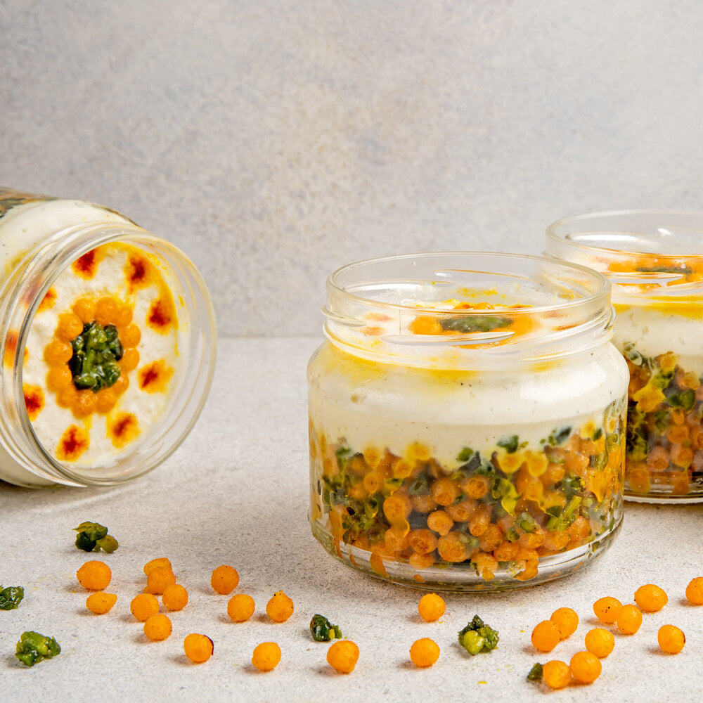 Elegantly layered jar with juicy Kesariya Boondi, rich pistachios, and creamy Kalakand, creating a visually appealing dessert presentation