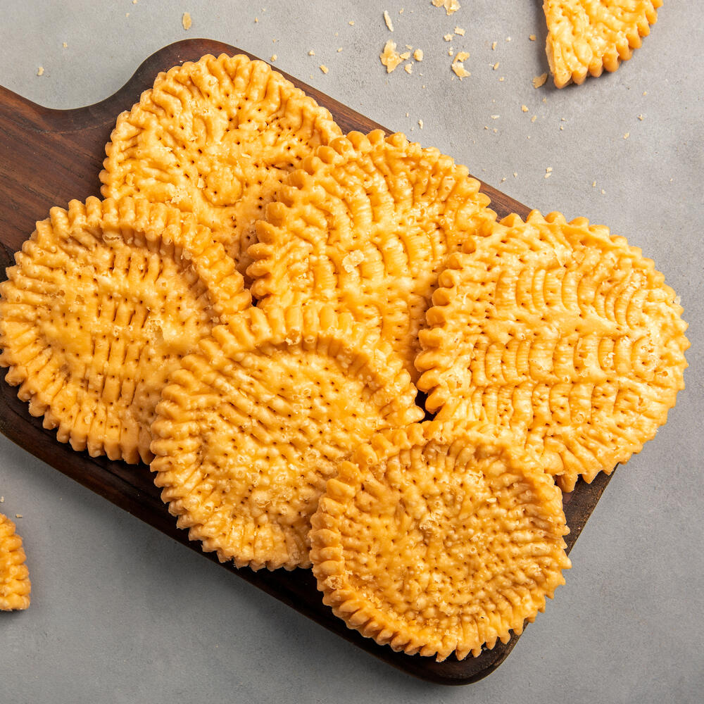Tray of circular golden mathris, perfect for tea time snacking