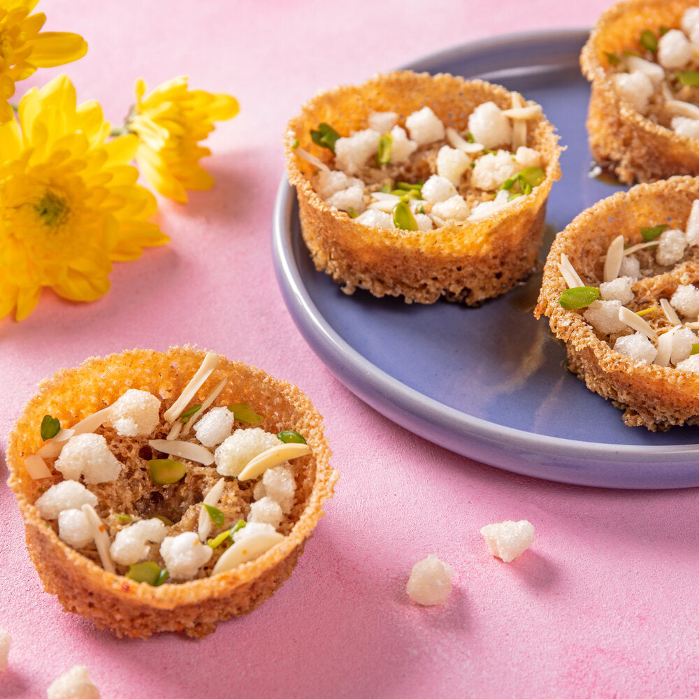 mini gud ghewar adorned with gond and slivers of dry fruit