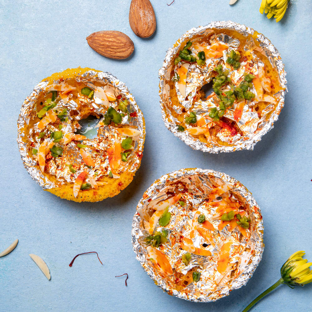 Mini kesaria ghewar adorned with silver varak and slivers of dry fruit