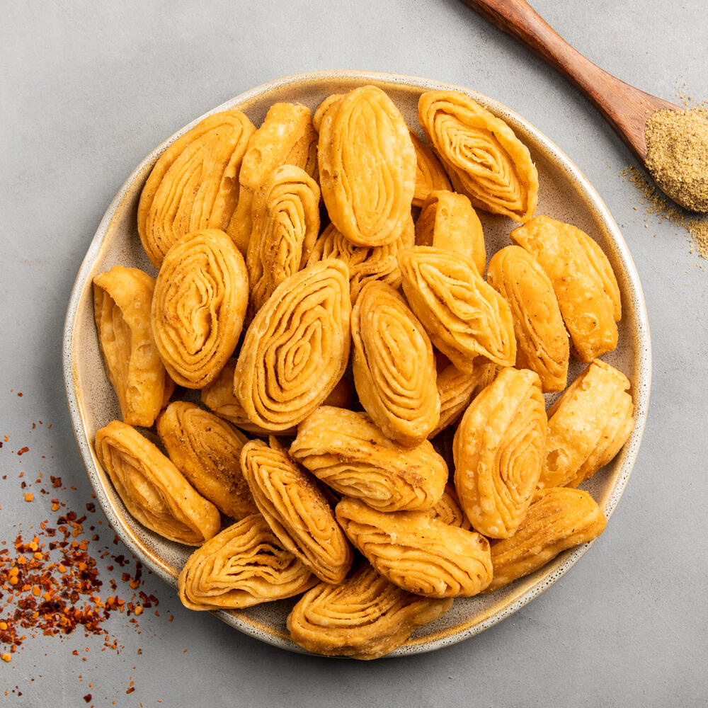 A bowl of mini masala khaja, perfect for tea time snacking